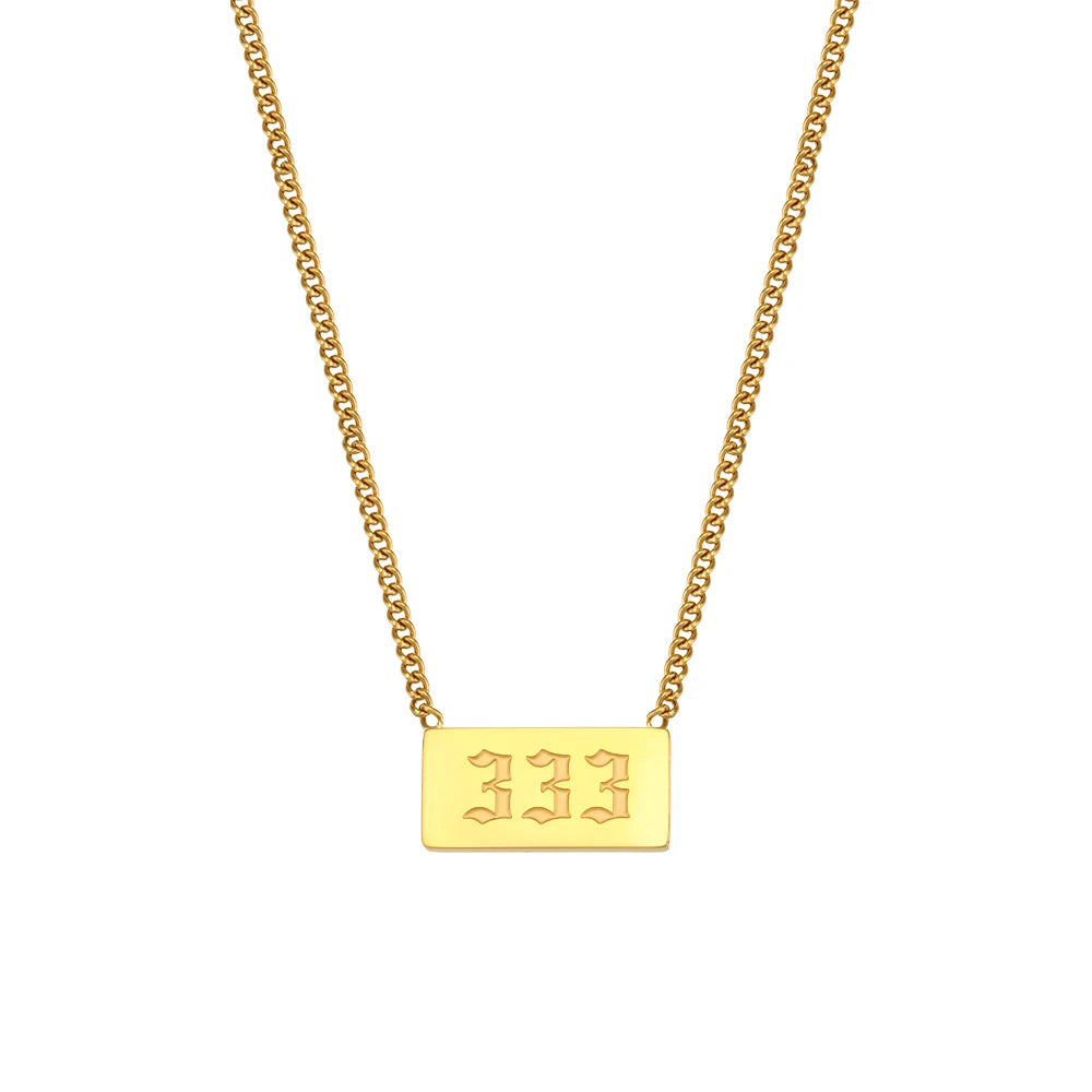 Gold necklace with a rectangular pendant on a white background