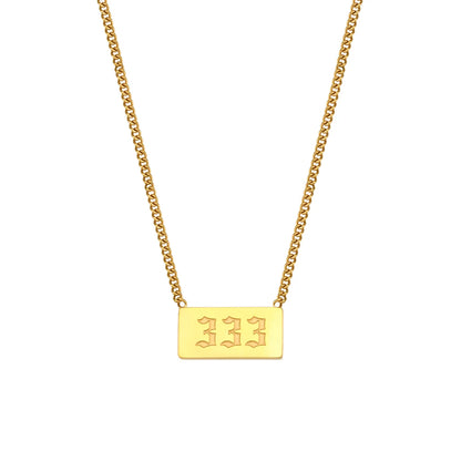 Gold necklace with a rectangular pendant on a white background