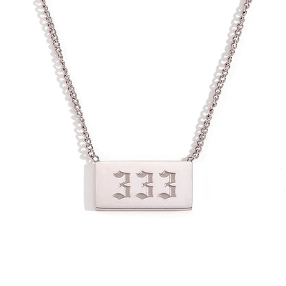 Silver necklace with a rectangular tag engraved with '333' on a white background