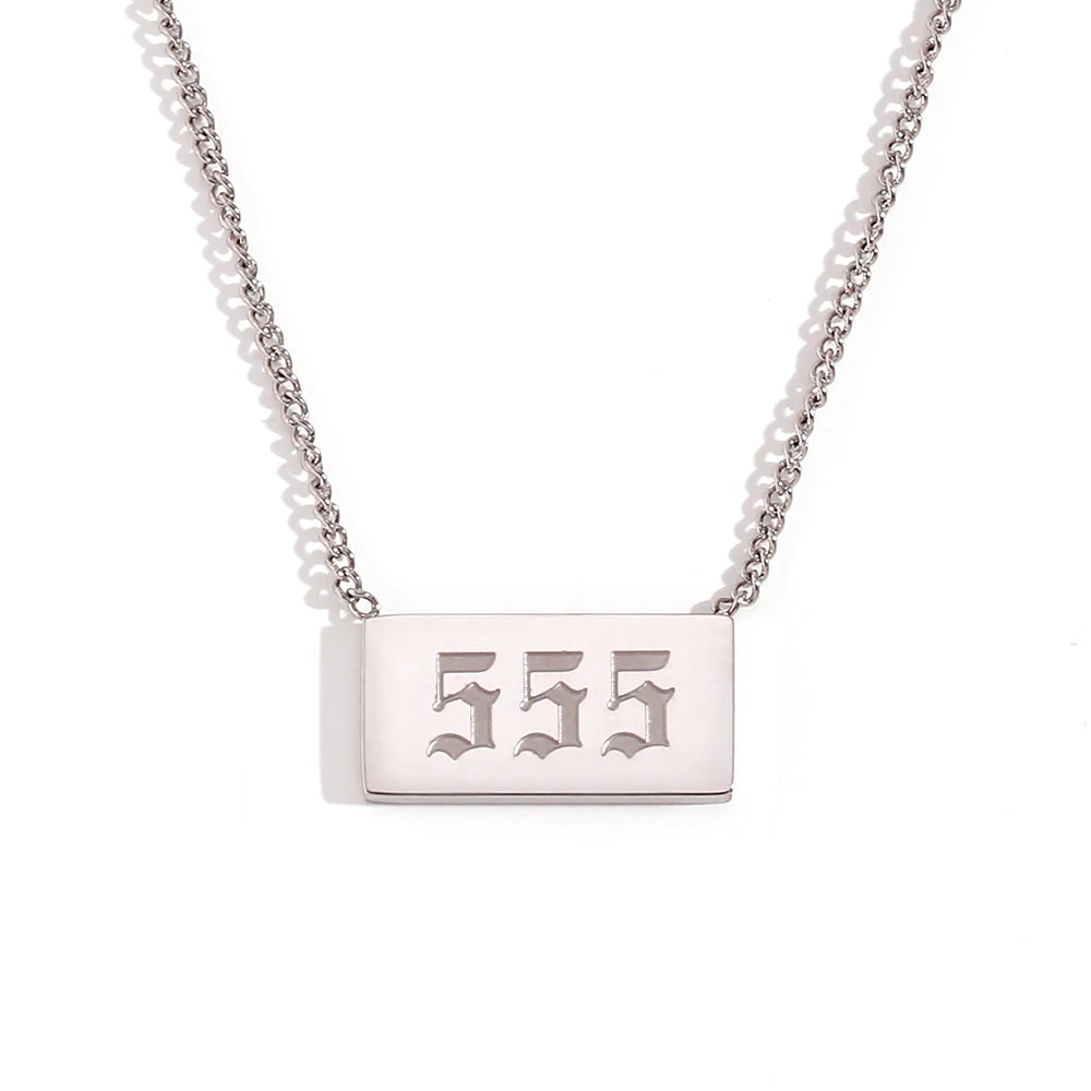 Silver necklace with a rectangular tag engraved with '555' on a white background